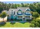 A close-up of a two-story home with a charming front porch, manicured lawn, and lush landscaping at 227 Paraggi Ct, Clayton, NC 27527
