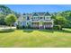 Beautiful two-story blue house with a welcoming front porch and a lush green lawn at 227 Paraggi Ct, Clayton, NC 27527