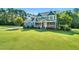 Beautiful two-story blue home with a well-manicured lawn and lush green trees at 227 Paraggi Ct, Clayton, NC 27527