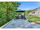 Cozy backyard gazebo with chairs and outdoor fireplace in backyard near inground pool at 227 Paraggi Ct, Clayton, NC 27527
