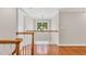 Hallway overlooking the staircase features hardwood floors and hanging chandelier at 227 Paraggi Ct, Clayton, NC 27527