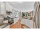 Contemporary kitchen featuring white cabinets, stainless appliances, and granite countertops at 227 Paraggi Ct, Clayton, NC 27527