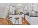 Stylish kitchen with white cabinets, granite countertops, stainless steel appliances, and breakfast bar at 227 Paraggi Ct, Clayton, NC 27527