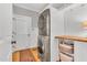 Functional laundry area with stacked washer and dryer, storage shelves, and exterior door access at 227 Paraggi Ct, Clayton, NC 27527