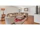Comfortable living room with a sectional sofa, hardwood floors, and a decorative rug, perfect for relaxation at 227 Paraggi Ct, Clayton, NC 27527