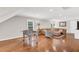 Spacious living room featuring a sectional sofa, foosball table, hardwood floors, and natural lighting at 227 Paraggi Ct, Clayton, NC 27527