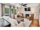 Inviting living room with fireplace, ceiling fan, and large windows offering a view of the outside deck at 227 Paraggi Ct, Clayton, NC 27527
