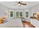 Bedroom boasts large windows, hardwood floors, and ceiling fan at 227 Paraggi Ct, Clayton, NC 27527