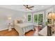 Bedroom features hardwood floors, ceiling fan, and large windows with backyard views at 227 Paraggi Ct, Clayton, NC 27527