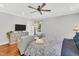 Bright main bedroom features ceiling fan, hardwood floors, and neutral paint at 227 Paraggi Ct, Clayton, NC 27527