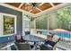 Covered patio with ceiling fan, a table with chairs, and a view of the swimming pool at 227 Paraggi Ct, Clayton, NC 27527