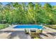 Backyard featuring a sparkling blue pool and outdoor seating, perfect for entertaining at 227 Paraggi Ct, Clayton, NC 27527