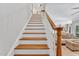 Carpeted stairs feature wood railing and banister at 227 Paraggi Ct, Clayton, NC 27527