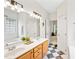 Bright bathroom featuring shower, jacuzzi, tiled floor, double sink, and access to bedroom at 2305 Bryarton Woods Dr, Raleigh, NC 27606