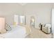 Bright bedroom featuring white linens, decorative pillows, large mirror, chair, and access to bath at 2305 Bryarton Woods Dr, Raleigh, NC 27606