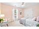 Light and airy bedroom featuring a bed, desk, closet, and large window with sheer curtains at 2305 Bryarton Woods Dr, Raleigh, NC 27606