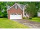 Beautiful brick home with a two-car garage and solar panels on the roof at 2305 Bryarton Woods Dr, Raleigh, NC 27606
