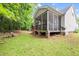 Exterior view of a screened porch and patio with a hot tub in the backyard, perfect for leisure at 2305 Bryarton Woods Dr, Raleigh, NC 27606