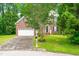 Charming two-story brick home with a well-manicured lawn and an attached two-car garage at 2305 Bryarton Woods Dr, Raleigh, NC 27606