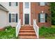 Inviting front entrance featuring a brick staircase and white railings at 2305 Bryarton Woods Dr, Raleigh, NC 27606