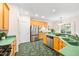 Bright kitchen with stainless steel appliances, green countertops, and stylish tile flooring at 2305 Bryarton Woods Dr, Raleigh, NC 27606