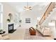 Bright and airy living room featuring a fireplace and staircase at 2305 Bryarton Woods Dr, Raleigh, NC 27606