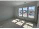 Bedroom with ample natural light through windows and views of nearby homes and foliage at 256 Meadowbark Bnd # 45, Garner, NC 27529