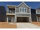 New construction two-story home boasts a gray exterior with a two-car garage and modern architectural design at 256 Meadowbark Bnd # 45, Garner, NC 27529