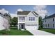 Charming two-story home with gray siding and a front-facing two car garage at 256 Meadowbark Bnd # 45, Garner, NC 27529