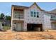 New construction of a two-story home with visible framing and large window openings at 256 Meadowbark Bnd # 45, Garner, NC 27529