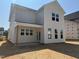 Exterior back of a two-story home showcasing a covered patio and multiple windows at 264 Meadowbark Bnd # 43, Garner, NC 27529