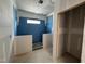 Bathroom with partially tiled walls and a walk-in closet at 264 Meadowbark Bnd # 43, Garner, NC 27529