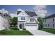 Charming two-story home with a two-car garage, lush green lawn, and traditional architectural details at 264 Meadowbark Bnd # 43, Garner, NC 27529