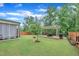 Landscaped backyard featuring a pergola with outdoor dining and a lush lawn at 2721 Jazzy St, New Hill, NC 27562