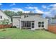 View of the backyard featuring a screened porch and well-maintained lawn at 2721 Jazzy St, New Hill, NC 27562