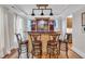 Interior bar with hardwood floors, a stone backsplash and accent lighting at 2721 Jazzy St, New Hill, NC 27562