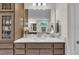 Neutral toned bathroom featuring built-in shelving and large mirrors at 2721 Jazzy St, New Hill, NC 27562