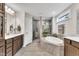 Beautiful bathroom featuring a large soaking tub, a walk-in shower, and wooden cabinets at 2721 Jazzy St, New Hill, NC 27562