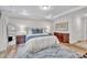 Spacious bedroom with wood floors, elegant furniture, and natural light, with access to en suite bathroom at 2721 Jazzy St, New Hill, NC 27562