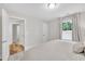 Neutral toned primary bedroom featuring soft carpet and an ensuite bath at 2721 Jazzy St, New Hill, NC 27562