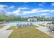 Large community pool with lounge chairs, umbrellas, and a pool house at 2721 Jazzy St, New Hill, NC 27562
