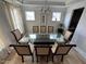 Bright dining area featuring seating for eight and modern chandelier at 2721 Jazzy St, New Hill, NC 27562