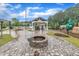 Community fire pit with grill, seating, and playground nearby at 2721 Jazzy St, New Hill, NC 27562
