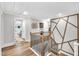 Upstairs hallway featuring hardwood floors and stylish architectural details at 2721 Jazzy St, New Hill, NC 27562