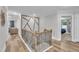 Hallway with wood floors, custom trim and decorative railing leading to a bedroom and a living area at 2721 Jazzy St, New Hill, NC 27562