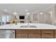 Kitchen island with sink overlooking the living room featuring a stone fireplace at 2721 Jazzy St, New Hill, NC 27562
