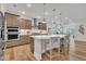 Large kitchen boasts stainless appliances, light countertops, island with barstool seating at 2721 Jazzy St, New Hill, NC 27562