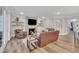 Comfortable living room with stone fireplace, leather seating, and open floor plan at 2721 Jazzy St, New Hill, NC 27562