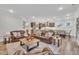 Open-concept living room, kitchen, and dining area with hardwood floors and ample light at 2721 Jazzy St, New Hill, NC 27562