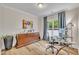 Bright home office with hardwood floors, large window, desk, cabinet, and neutral paint at 2721 Jazzy St, New Hill, NC 27562